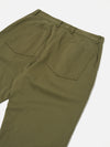 Close-up of the back of light olive twill Duke Pant on a white surface. The pants have a relaxed fit and visible back pockets.
