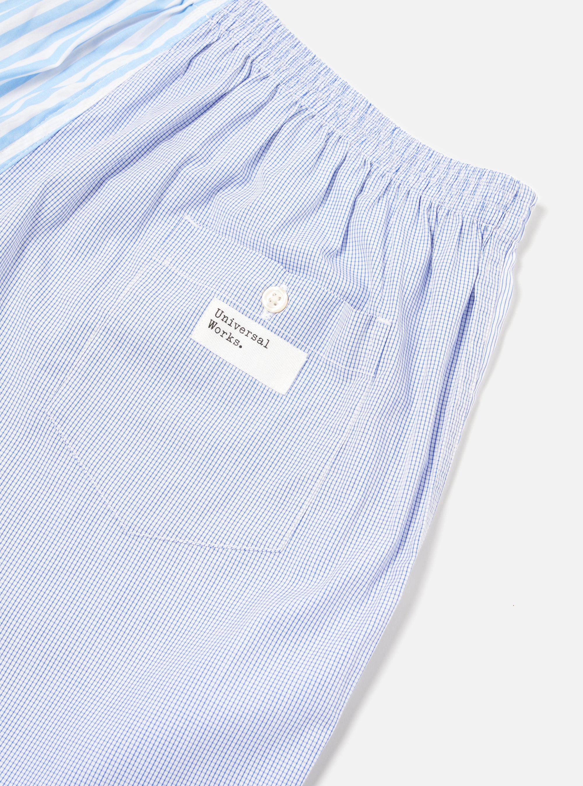 Close-up of the Blue Classic Mix Boxer Short on a white surface. Features blue stripes and a blue grid pattern. The boxer short has an elastic waist and a small pocket.