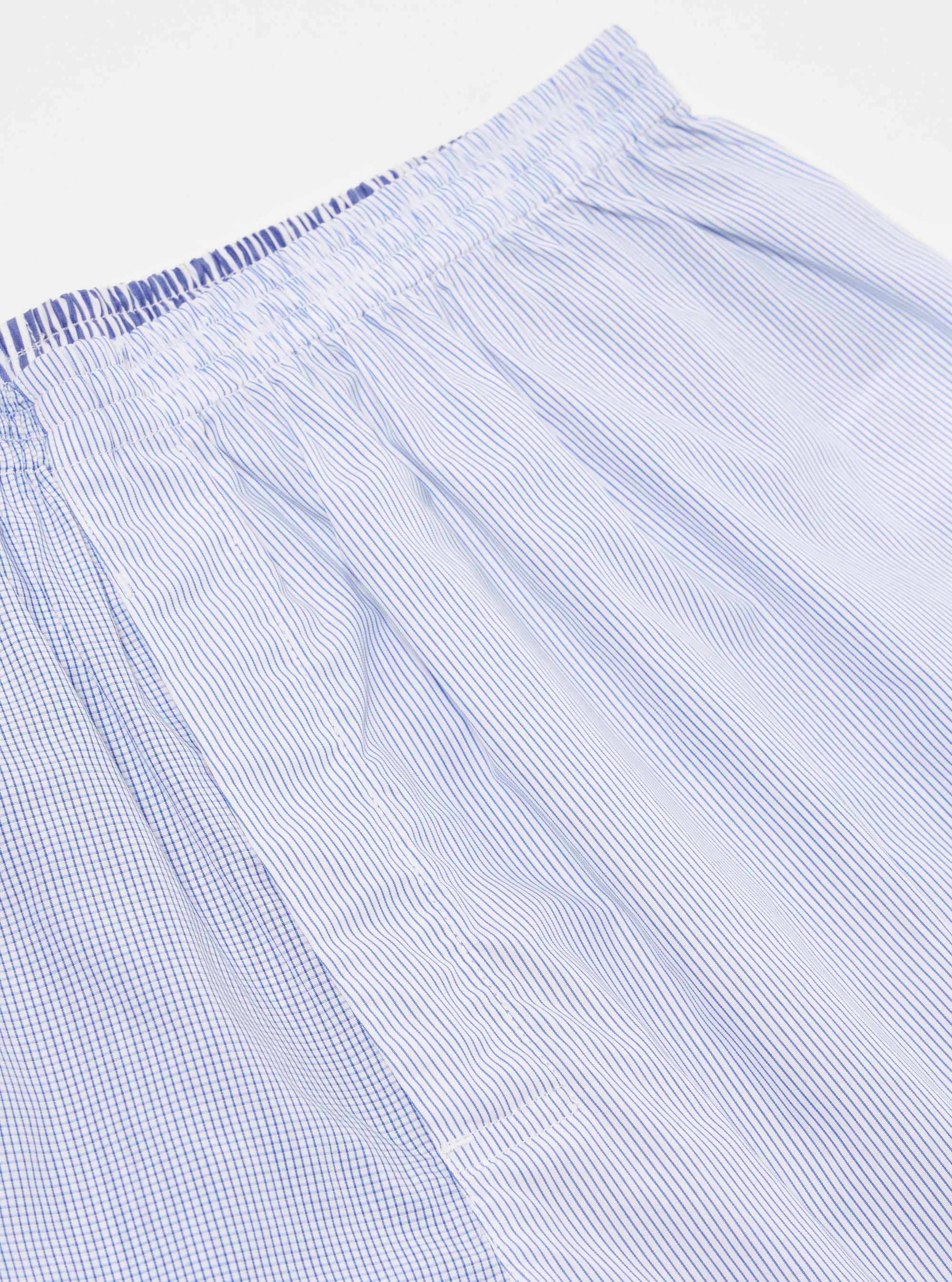 Close-up of the Blue Classic Mix Boxer Short on a white background. The fabric is a mix of blue and white stripes and checks, with an elastic waistband.