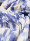 Close-up of the Ecru Ikat I Cotton Boxer Short fabric. Features a blue and white pattern. The material is bunched on a flat surface.