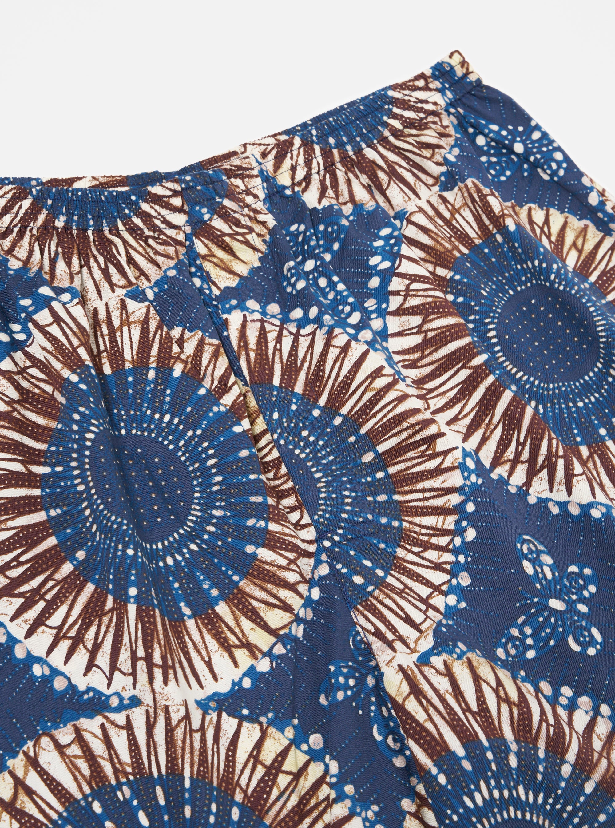 Close-up of the Navy Hokkoh Print Boxer Short on a white surface. The shorts feature a blue and brown floral pattern with an elastic waistband.