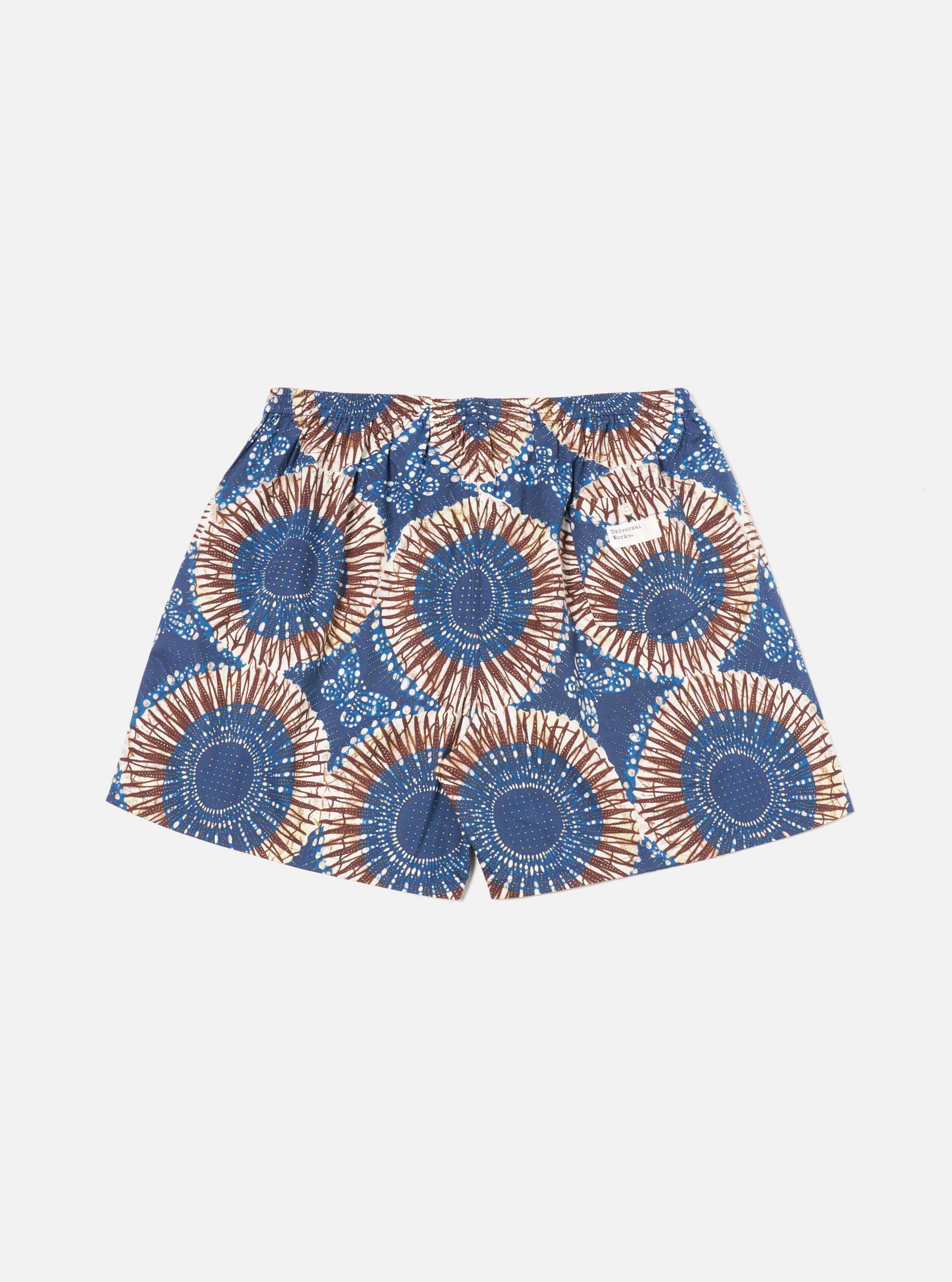 The Navy Hokkoh Print Boxer Short on a white background. The shorts have a blue and brown circular pattern. The fit is loose and comfortable.