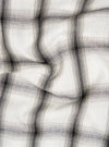 Close-up of the Ecru Shadow Check Pyjama Pant fabric. The soft, neutral-toned material features a subtle shadow check pattern, displayed on a flat surface with gentle folds.