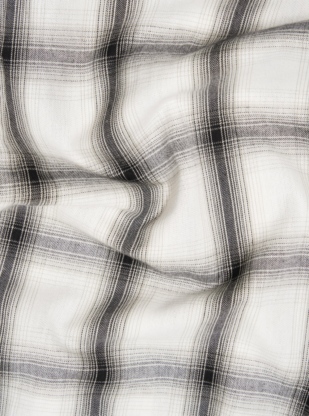Close-up of the Ecru Shadow Check Pyjama Pant fabric. The soft, neutral-toned material features a subtle shadow check pattern, displayed on a flat surface with gentle folds.