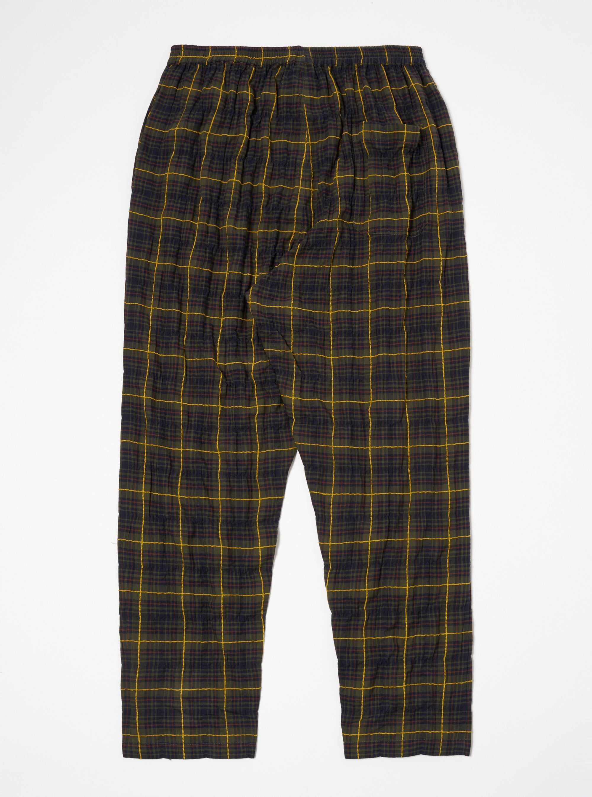 Flat lay of Olive JP Herringbone Check Pyjama Pant on a white surface. The pants have a relaxed fit and a yellow and brown check pattern.