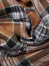 Close-up of the Brown Ikat Twill Check Long Pyjama Set fabric. The brown, black, and white twill check pattern is displayed in a folded arrangement.
