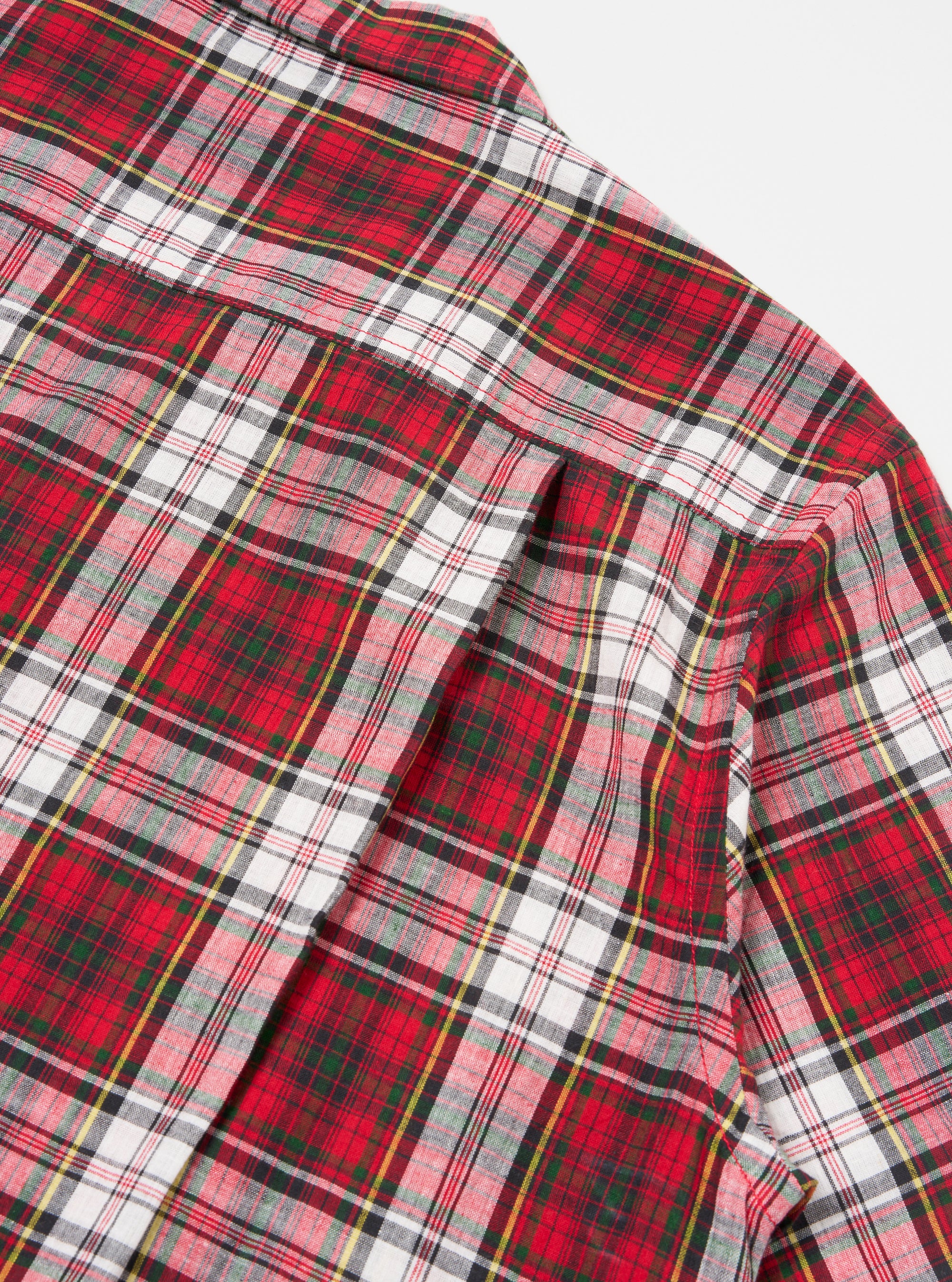 Close up of the Red Madras Check Short Pyjama Set. The fabric is red, white, green, yellow and black plaid. The set is on a white background.