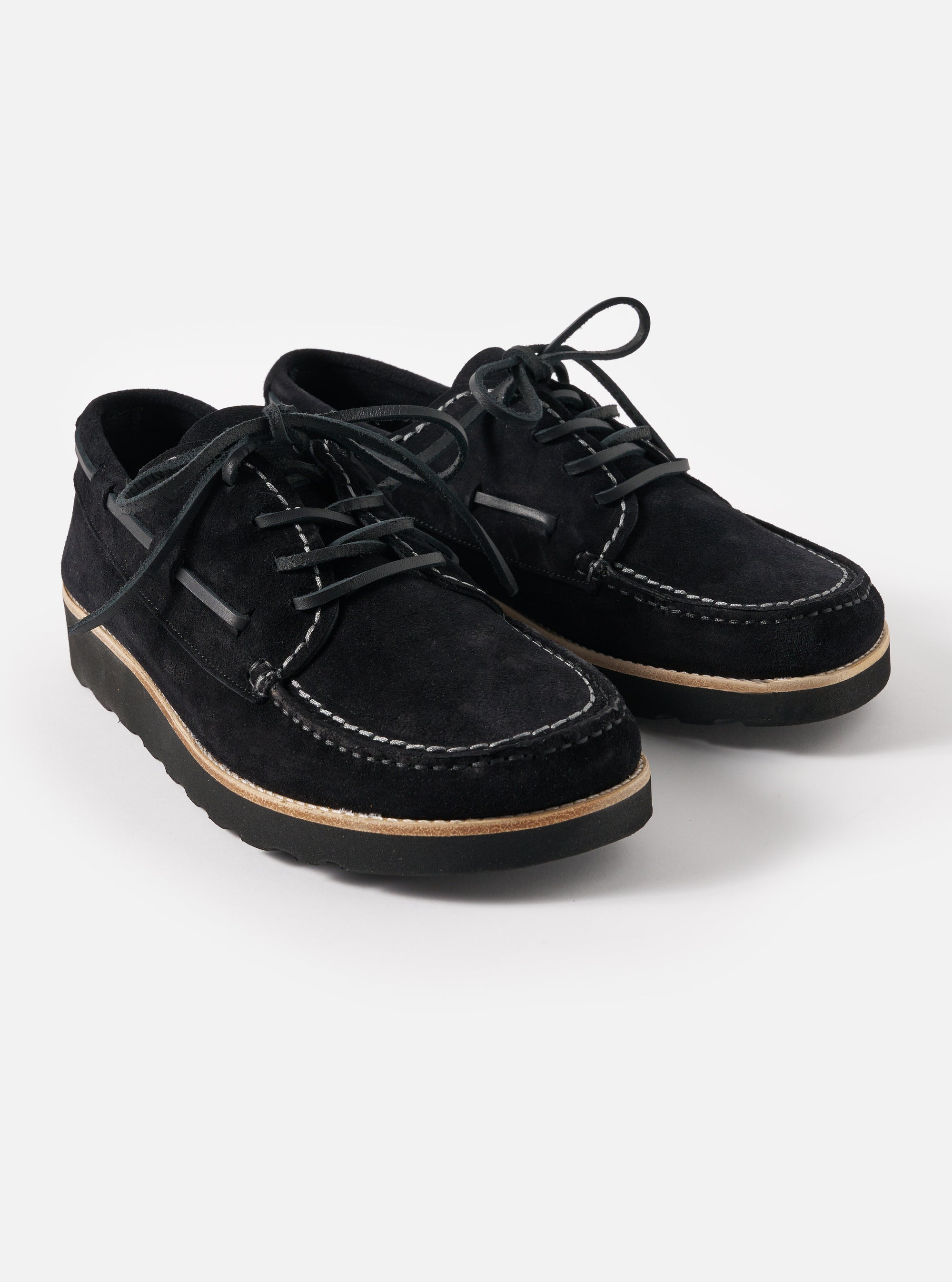 Studio shot of Zardus for Universal Works Black Suede Oliver shoes. The black suede shoes feature white stitching and are set against a clean, white background.