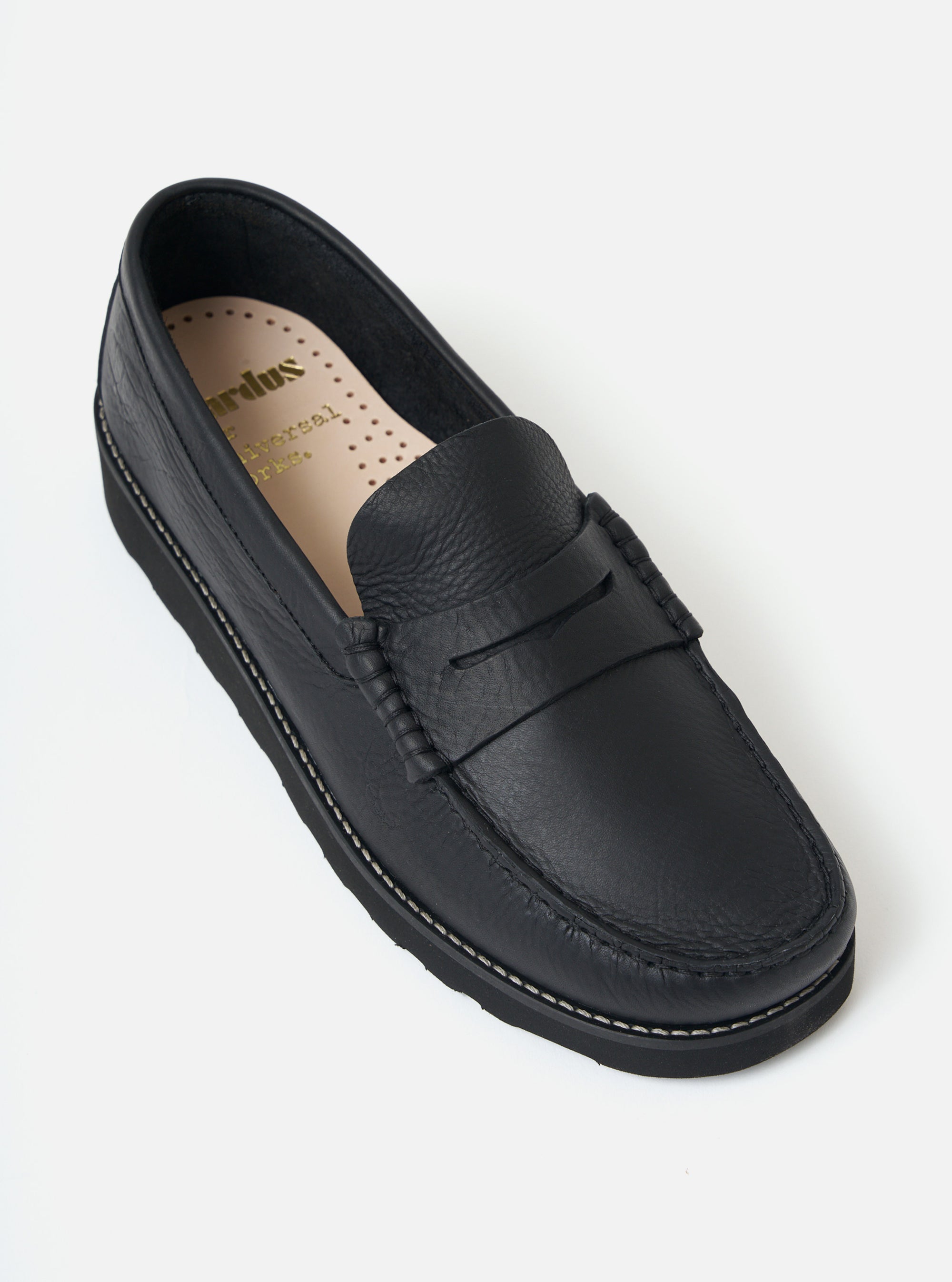 Close-up of a Zardus for Universal Works Black Leather Reggie Loafer on a white background. The shoe is black leather with a black sole.