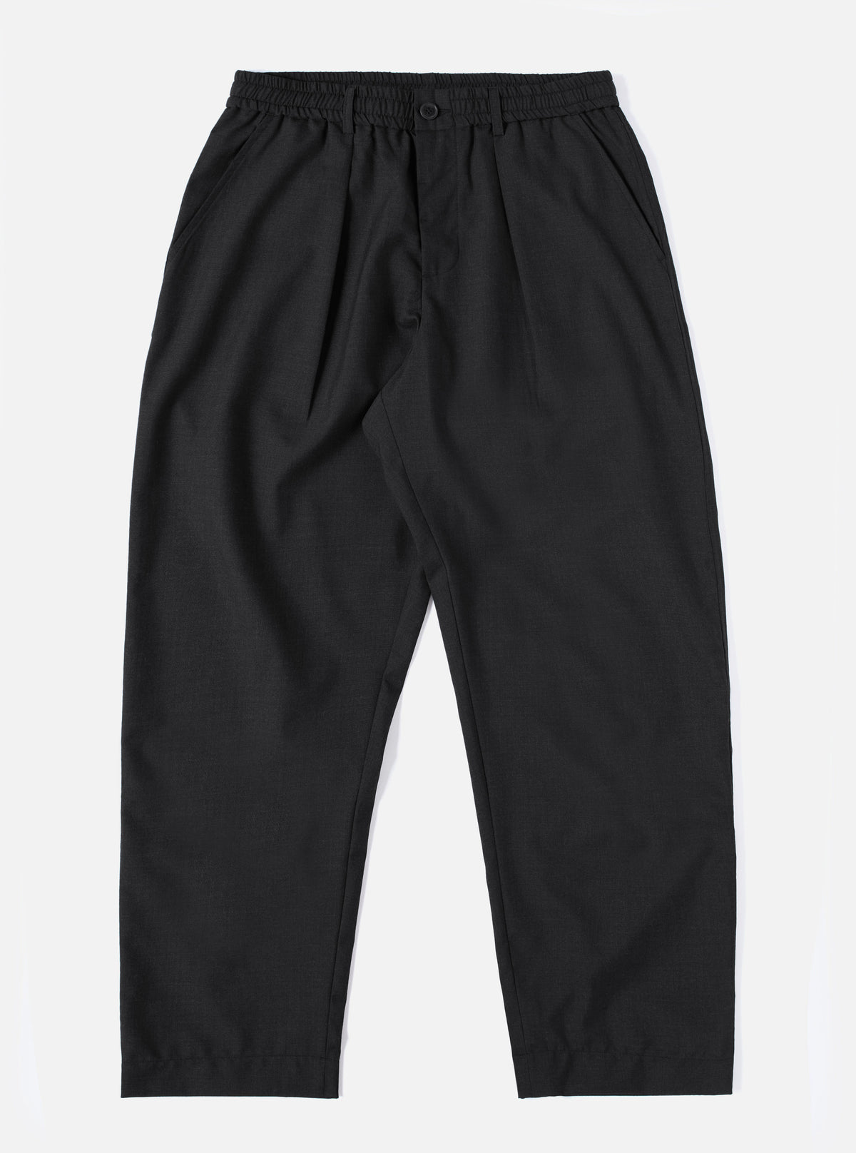 The Charcoal Tropical Suiting Oxford Pant is displayed on a white background. The pants are a dark charcoal color and have a relaxed fit.