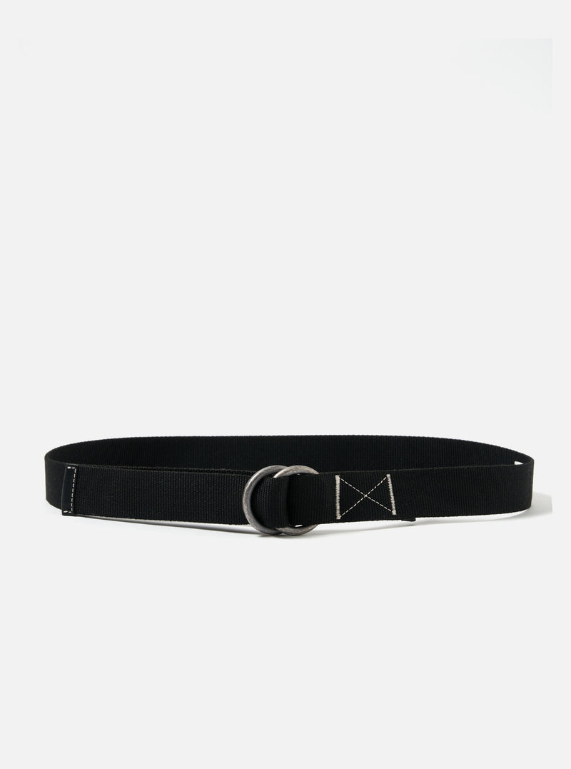 The Black Canvas O Ring Belt is displayed on a white background. The belt is black canvas with a silver O ring. Stitching details are visible.