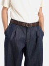 A model wears a Brown Leather O Ring Belt with dark denim pants and a cream shirt against a white background. The belt is brown leather with a silver O ring buckle.