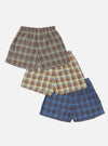 The Multi Check 3 Pack Boxer Short on a white background. The boxers are brown, yellow, and blue plaid. They have an elastic waist and a relaxed fit.