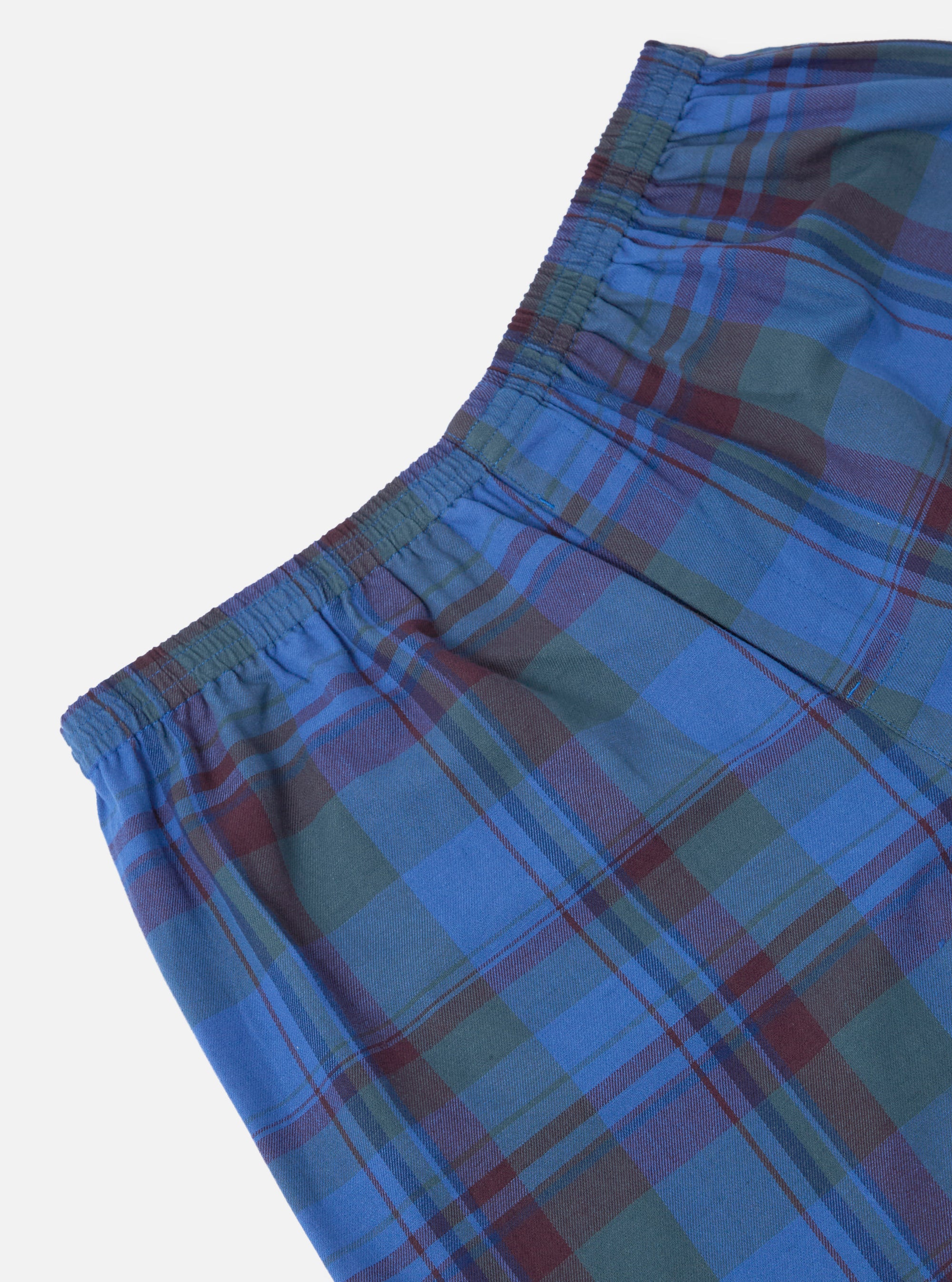 Close-up of Multi Kip Check 3 Pack Boxer Short. Blue, green, and maroon plaid pattern. Elastic waistband. Cotton material. Shot on a white background.