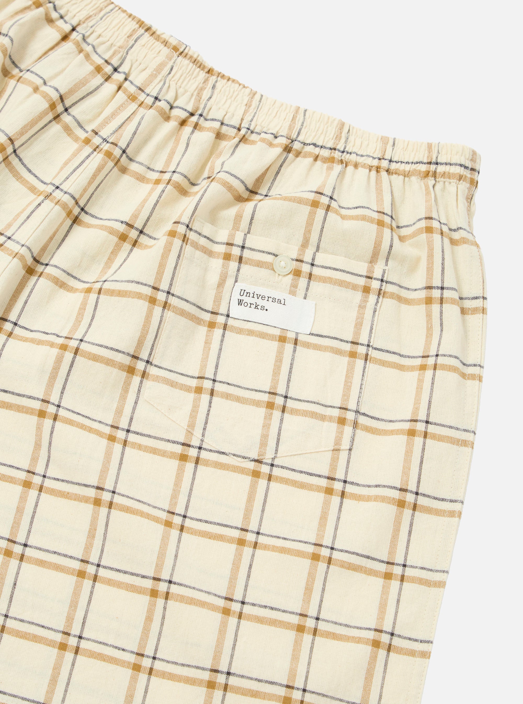 Close-up of the Multi PJ Plaid 3 Pack Boxer Short. Features a tan, brown, and black plaid pattern, elastic waist, and back pocket with a button. Shot on a white background.