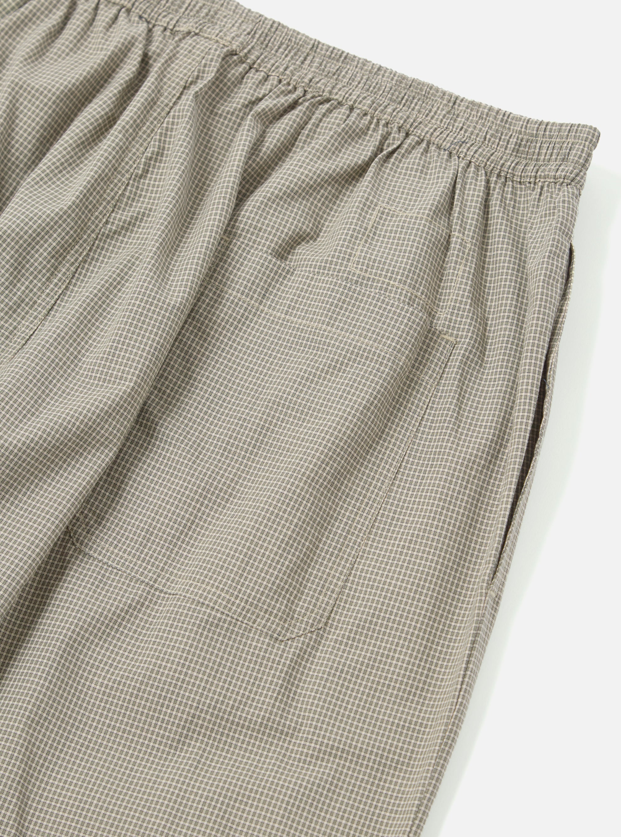 Close-up of the Green Tiny Check Long Pyjama Set bottoms, showing the elastic waist and side pocket. The fabric has a small green and white check pattern. Shot on a white background.