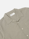 Close-up of the Green Tiny Check Long Pyjama Set top. The shirt is neatly folded on a white surface, showcasing its tiny green check pattern and relaxed fit.