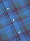 Close-up of the Blue Kip Check Long Pyjama Set. Features a blue, green, and maroon plaid pattern with white buttons. The fabric is soft and comfortable.