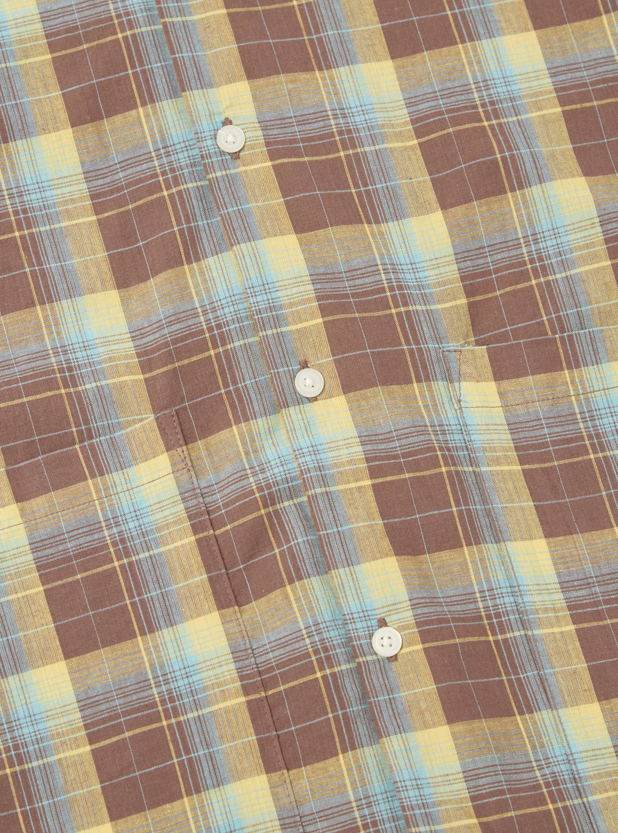 Close-up of the Yellow/Brown Check Short Pyjama Set. The fabric is a soft, brushed cotton with a classic check pattern. Features a chest pocket and button-down front. 