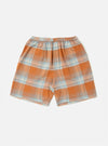 The Orange Check Pyjama Short, featuring a orange and blue plaid pattern, laid flat on a white background. The shorts have an elastic waistband.