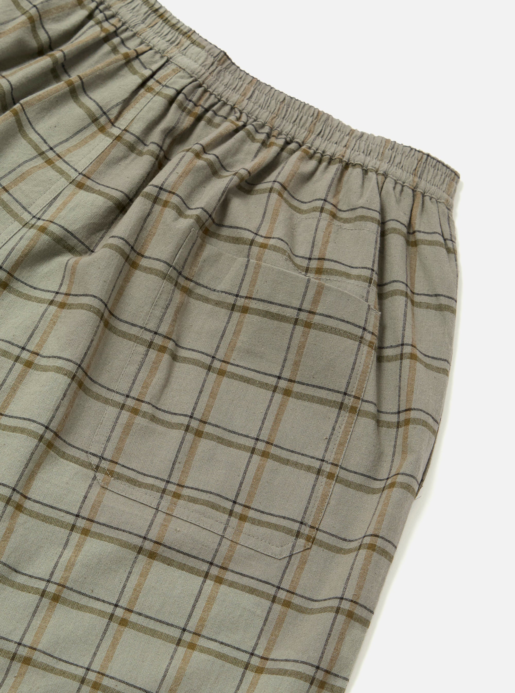 Close-up of the Green PJ Plaid Pyjama Short. The fabric is a soft, neutral plaid with brown and black lines. Elastic waistband and pocket are visible against a white background.