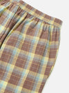 Close-up of the Yellow/Brown Check Pyjama Pant on a white surface. The fabric is a soft cotton blend with a relaxed fit, perfect for lounging.