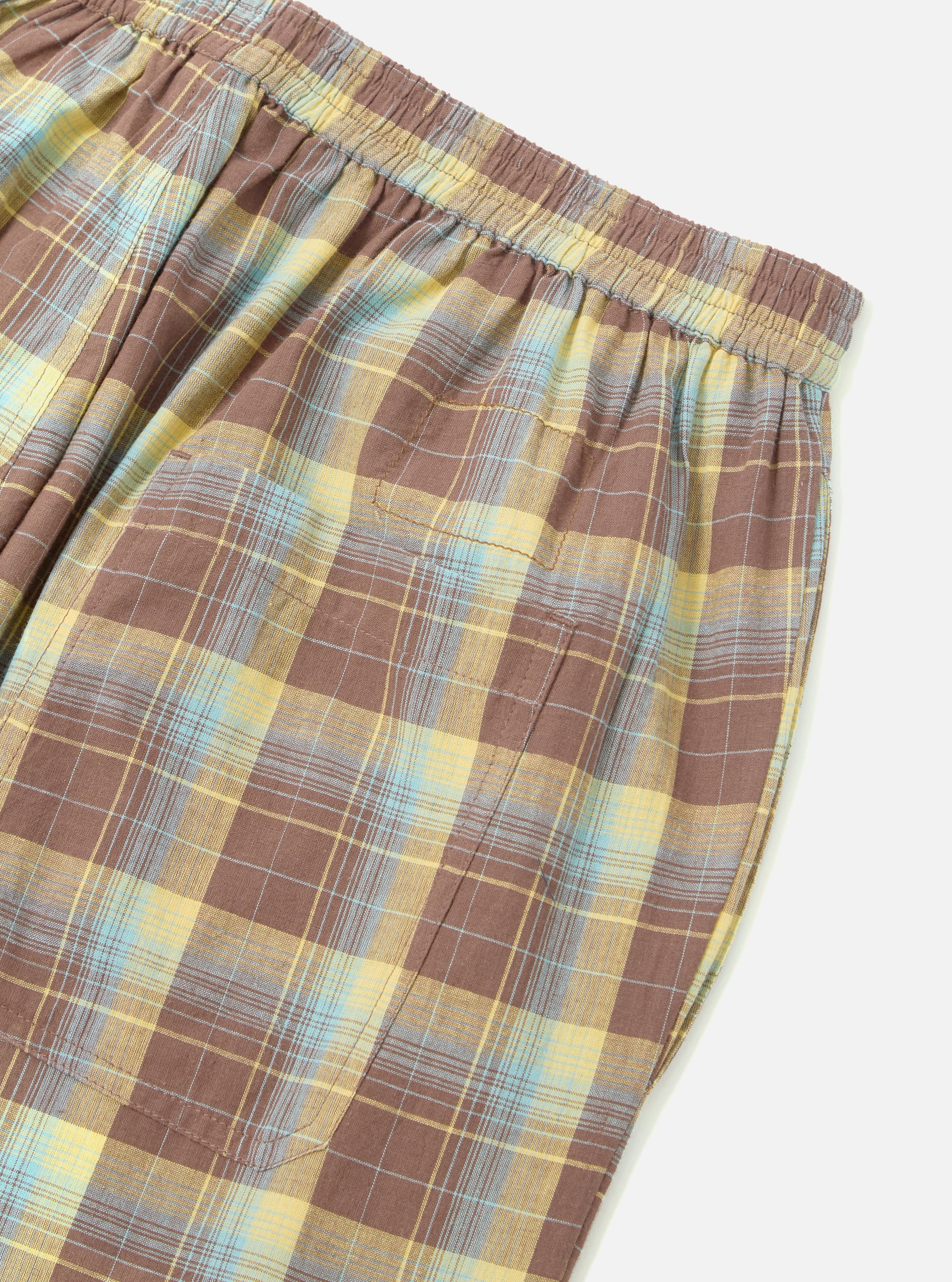 Close-up of the Yellow/Brown Check Pyjama Pant on a white surface. The fabric is a soft cotton blend with a relaxed fit, perfect for lounging.