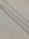 Close-up of the Green Tiny Check Pyjama Pant fabric. The material is a soft green and white tiny check pattern. The fabric is folded on a flat surface.