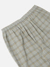 Close-up of the Green PJ Plaid Pyjama Pant on a white background. The pajama pant has a plaid pattern with green, yellow, and gray lines. The waist is elastic.