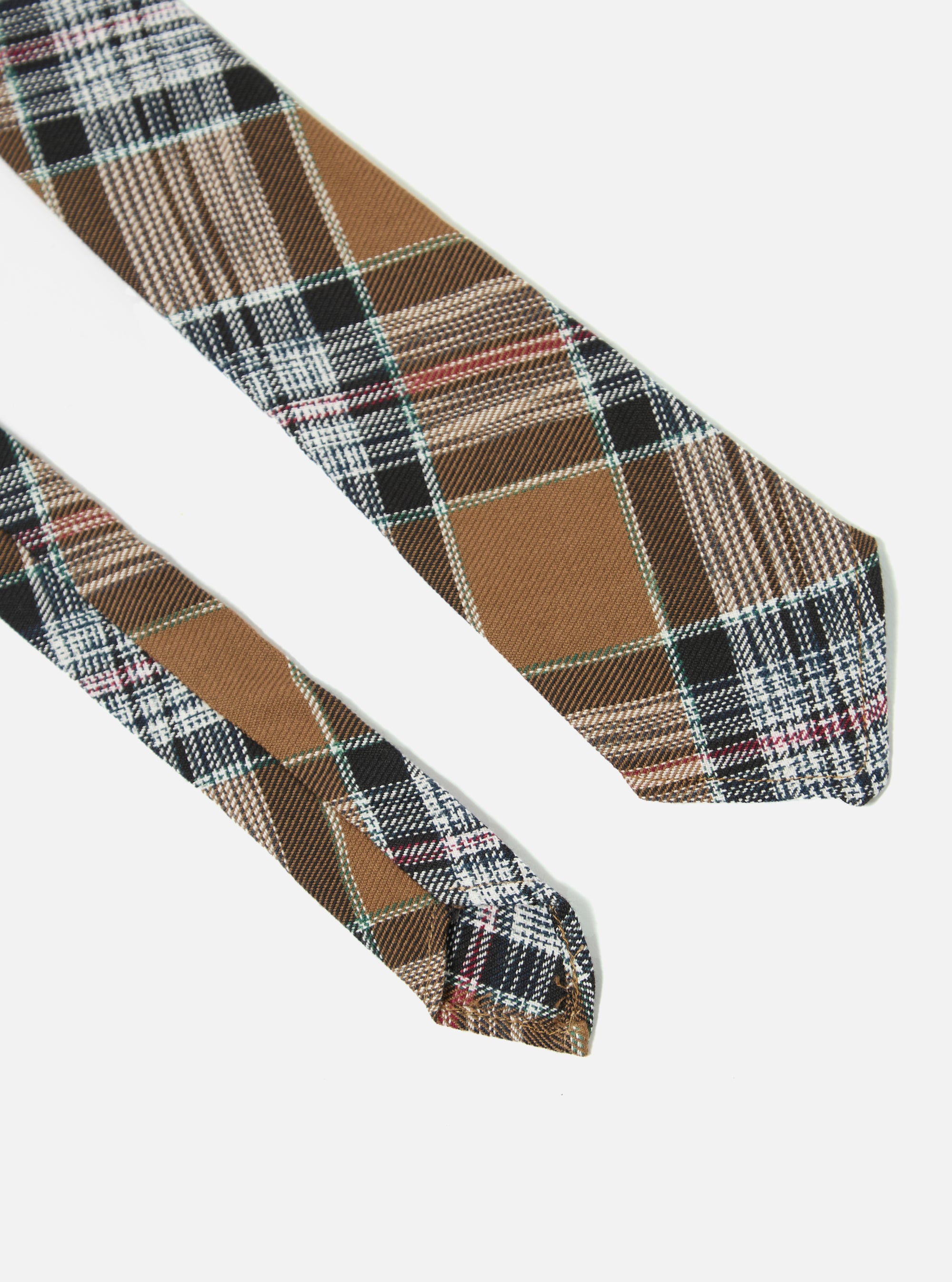 Close-up of a Brown Ikat Twill Check Tie on a white background. The tie features a brown, black, and white check pattern with subtle red and green accents.