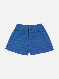 The Navy PJ Plaid Boxer Short on a white background. The boxer short is blue with a green and black plaid pattern and has an elastic waistband.