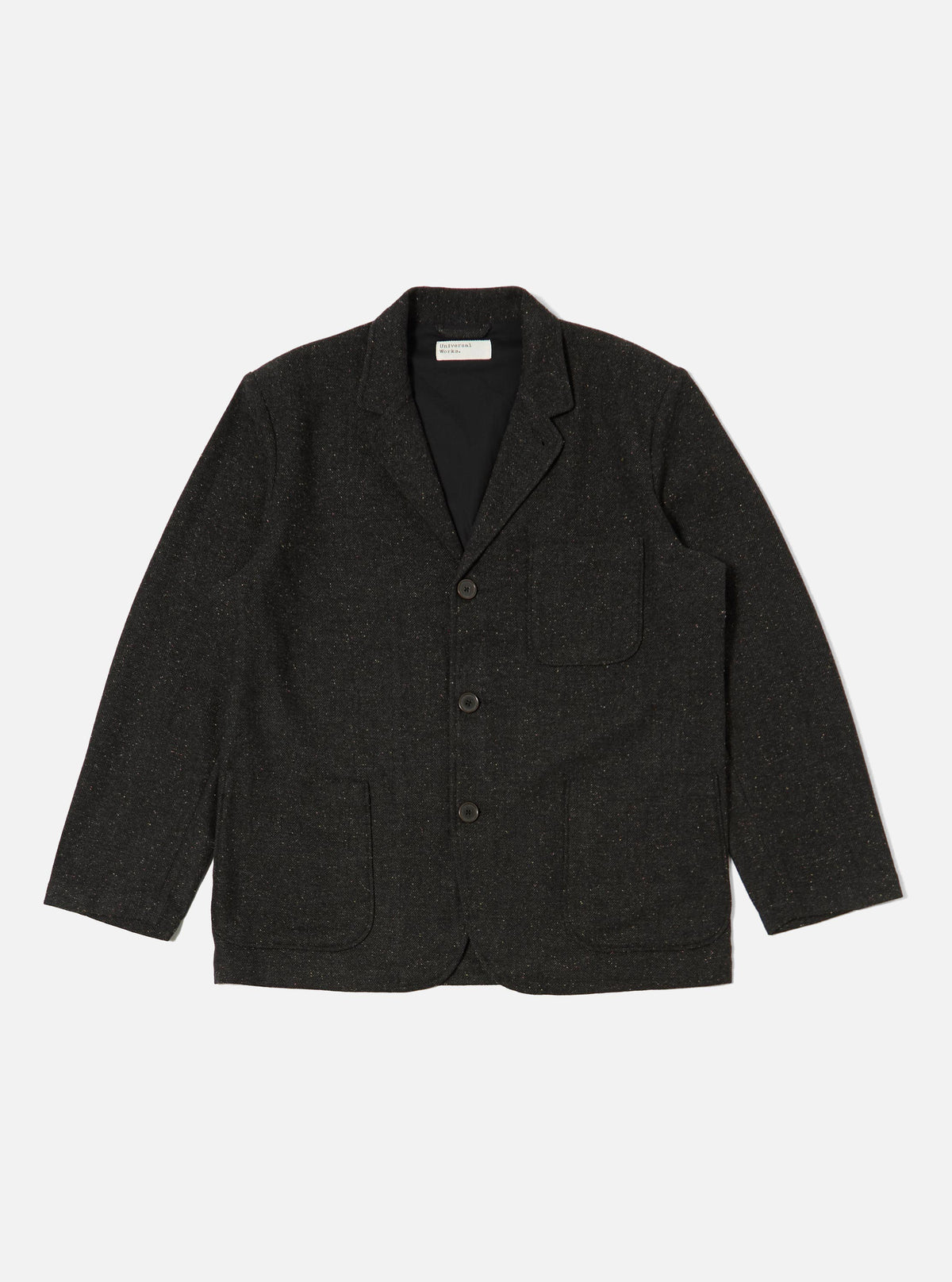 Studio shot of a Black Salt N Pepper Tweed Three Button Jacket laid flat on a white background. The tweed jacket has a classic fit and visible front pockets.