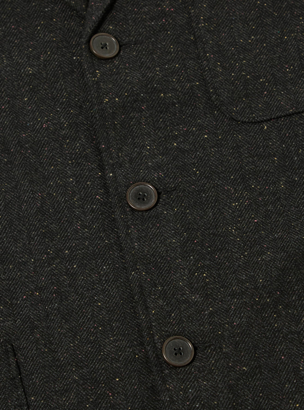 Close-up of the Black Salt N Pepper Tweed Three Button Jacket showing the tweed material and button details. The jacket is laid flat on a neutral surface.