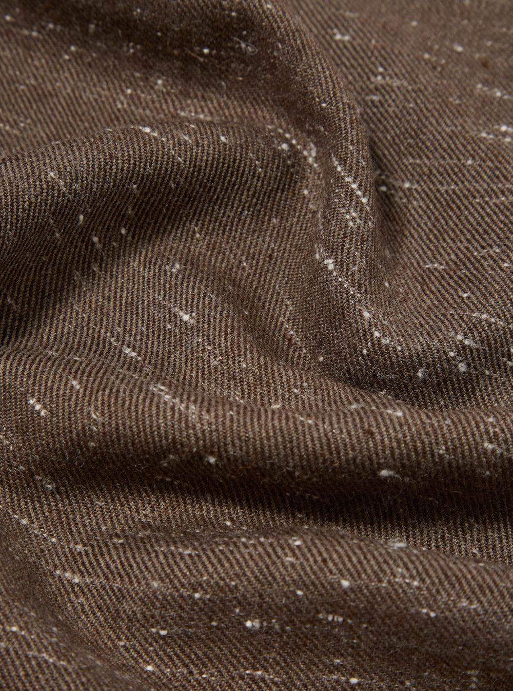 Close-up of a textured brown wool scarf with subtle white flecks. The fabric is draped to show its soft texture. Perfect for adding warmth and style.
