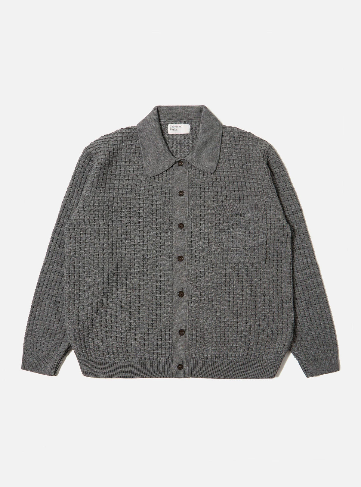 The Grey Textured Merino Knit Charlie Cardigan, laid flat on a white background. The cardigan is buttoned and features a textured knit and a small pocket.