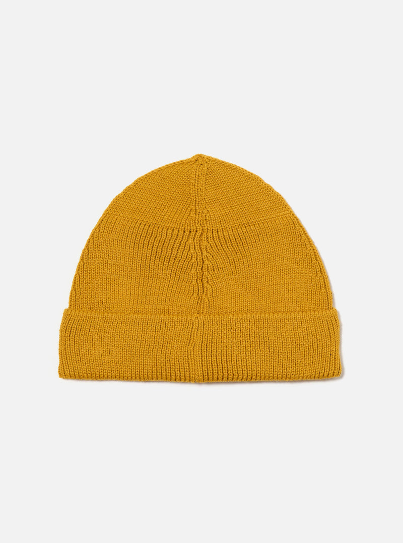Studio shot of a Gold Merino Knit Watch Cap on a white background. The knit is tight and the fit is snug.
