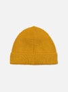 Studio shot of a Gold Merino Knit Watch Cap on a white background. The knit is tight and the fit is snug.