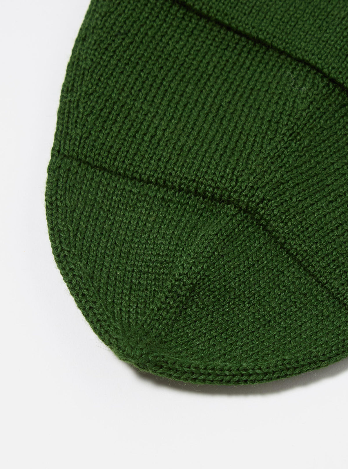 Close-up of the Green Merino Knit Watch Cap, showcasing the texture of the knit on a white background.