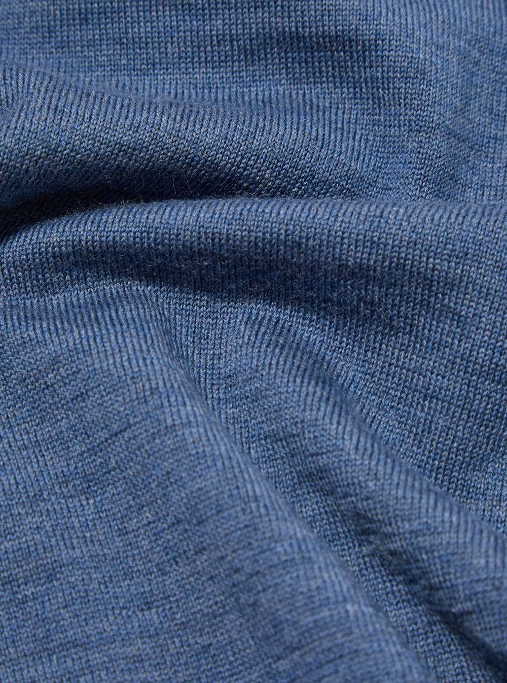 Close-up of the Airforce Blue Merino L/S Pullover Knit Shirt, showcasing the soft texture and fine knit of the merino wool. The fabric is draped to highlight its luxurious feel.