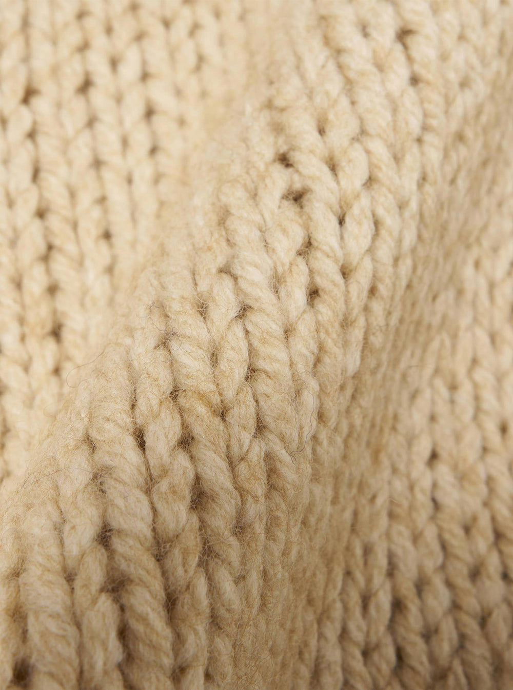 Close-up of the Sand Chunky Knit Stripe Langdale Cardigan, showing the texture and color of the knit. The chunky knit is soft and cozy.