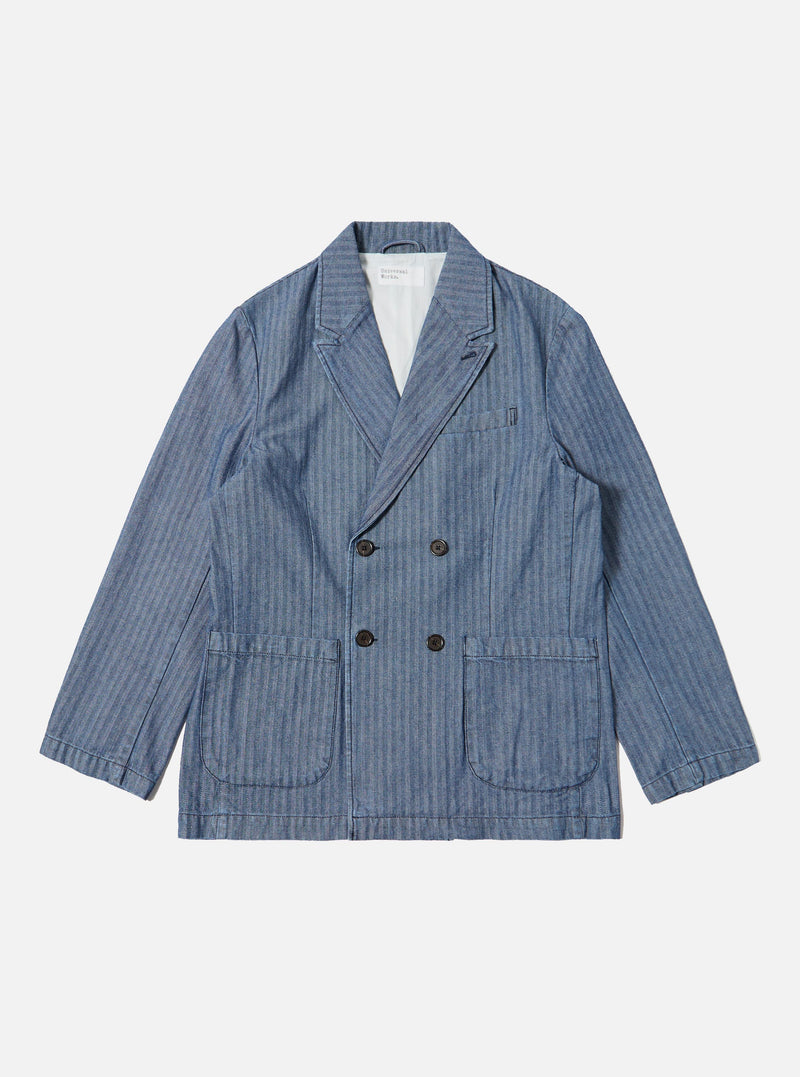 The Indigo Denim Herringbone Manor Jacket, a blue denim jacket with a herringbone pattern, is laid flat on a white background. The jacket is double-breasted with four buttons.