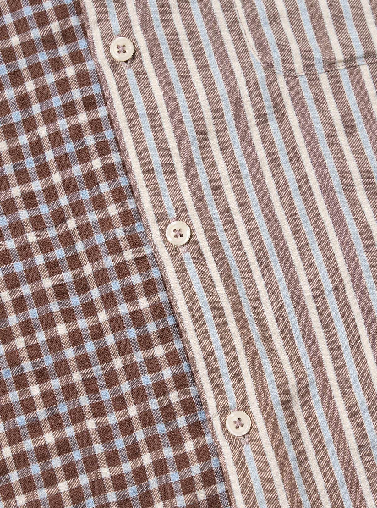 Close-up of the Brown Madison Check/Stripe Station Shirt. Features a brown and blue check pattern on one side and brown, white, and blue stripes on the other. White buttons are visible.