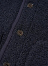 Rear view of a model wearing the Navy Alvar Fleece Lancaster Jacket against a clean off-white studio background. The shot focuses on the straight hem, comfortable fit across the back, and thick, insulating navy fleece construction.