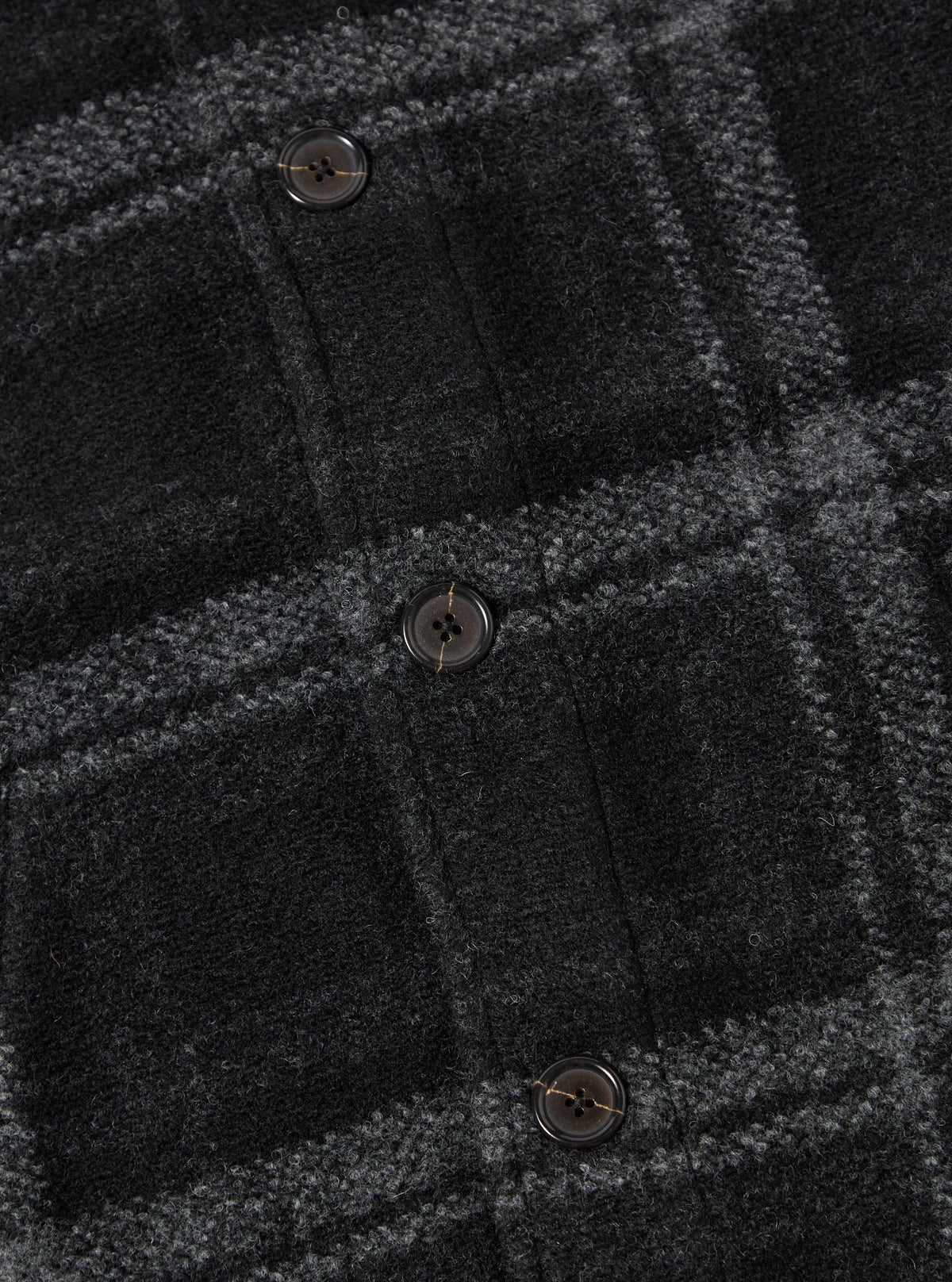 Close-up of the Grey Moh Check Fleece Button Front Bomber, showcasing the soft, textured fleece material and button details against a simple backdrop.