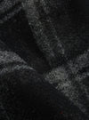 Close-up of the Grey Moh Check Fleece Button Front Bomber, showcasing the soft, textured fleece material with a subtle check pattern. The fabric's folds add depth to the image.