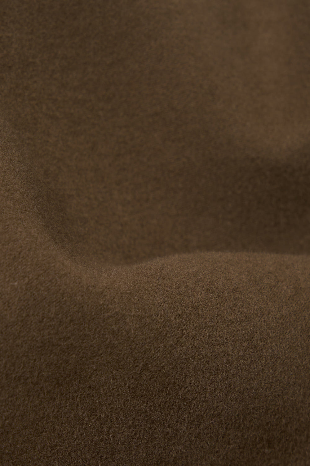 Close-up of the Khaki Comfort Moleskin Field Jacket fabric. The soft, textured moleskin is draped to show its quality. The khaki color is rich and warm.