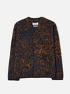 A male model stands against a plain studio background wearing the Dark Navy/Brown Night Leopard Cardigan. The image features the button front, v-neck collar, front patch pockets, and distinct dark navy and brown leopard print pattern.