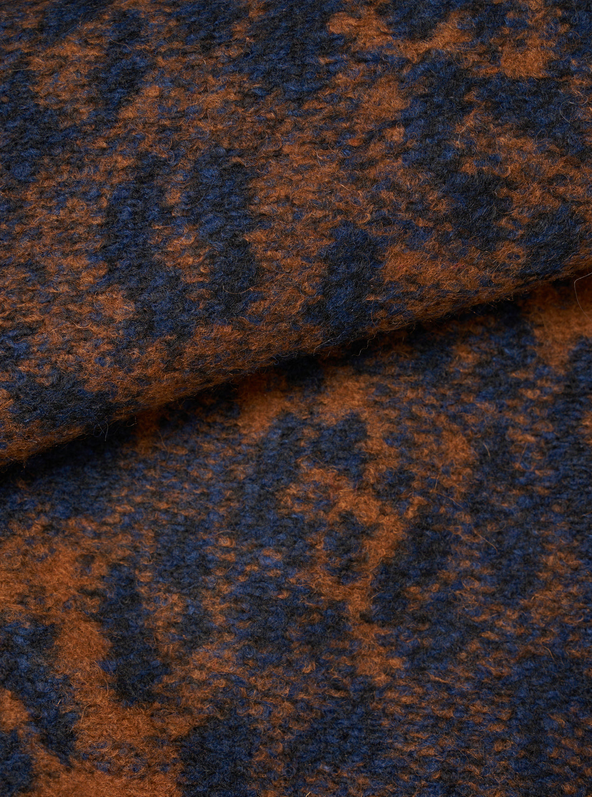 A fabric swatch image showcasing the Dark Navy/Brown Night Leopard Cardigan on a plain neutral background. The macro photograph details the woven jacquard leopard pattern and the rich, tactile wool and recycled polyester blend.