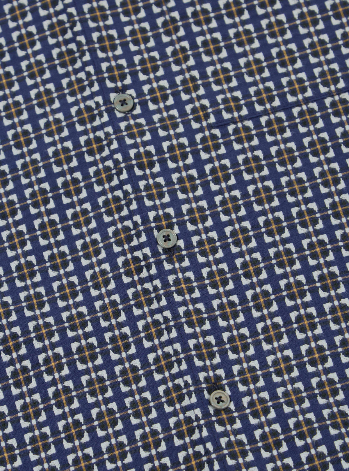 Close-up of the Navy Oscar Cotton L/S Camp Shirt. The shirt has a navy base with a white and gold pattern. The shirt is made of cotton and has a relaxed fit.