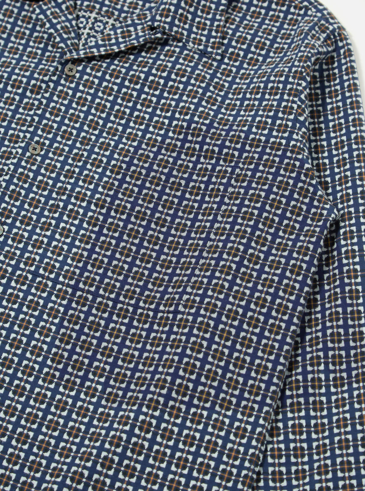 Close-up of the Navy Oscar Cotton L/S Camp Shirt. The shirt has a navy base with a white, black, and orange square pattern. The fabric is cotton and the fit is relaxed. Shot on a white surface.
